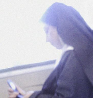 A nun checks her cellphone on a Metro-North train, presumably quietly